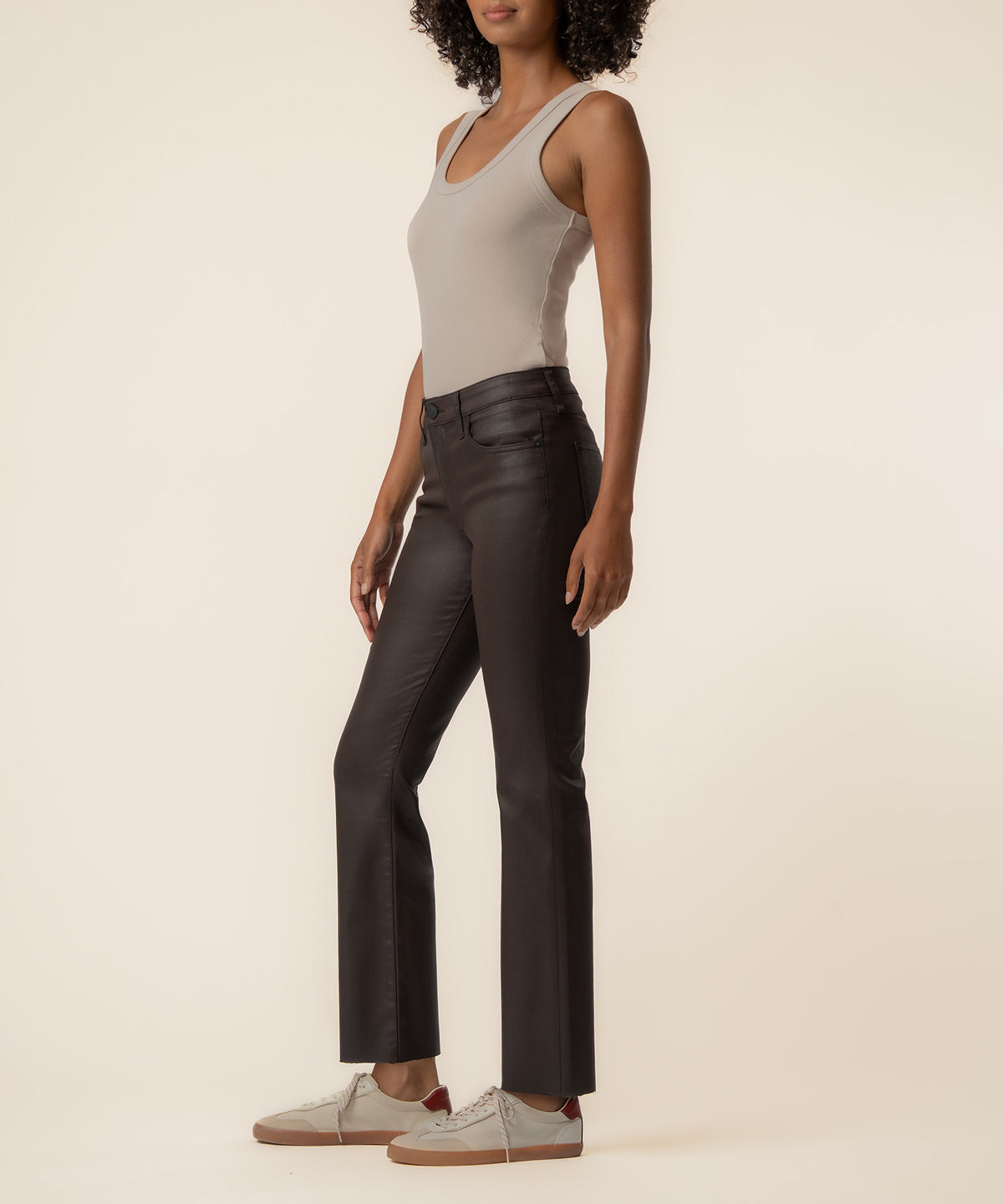 Chocolate coated high-rise ankle flare pants with flared hem, shown on model wearing cream tank top.