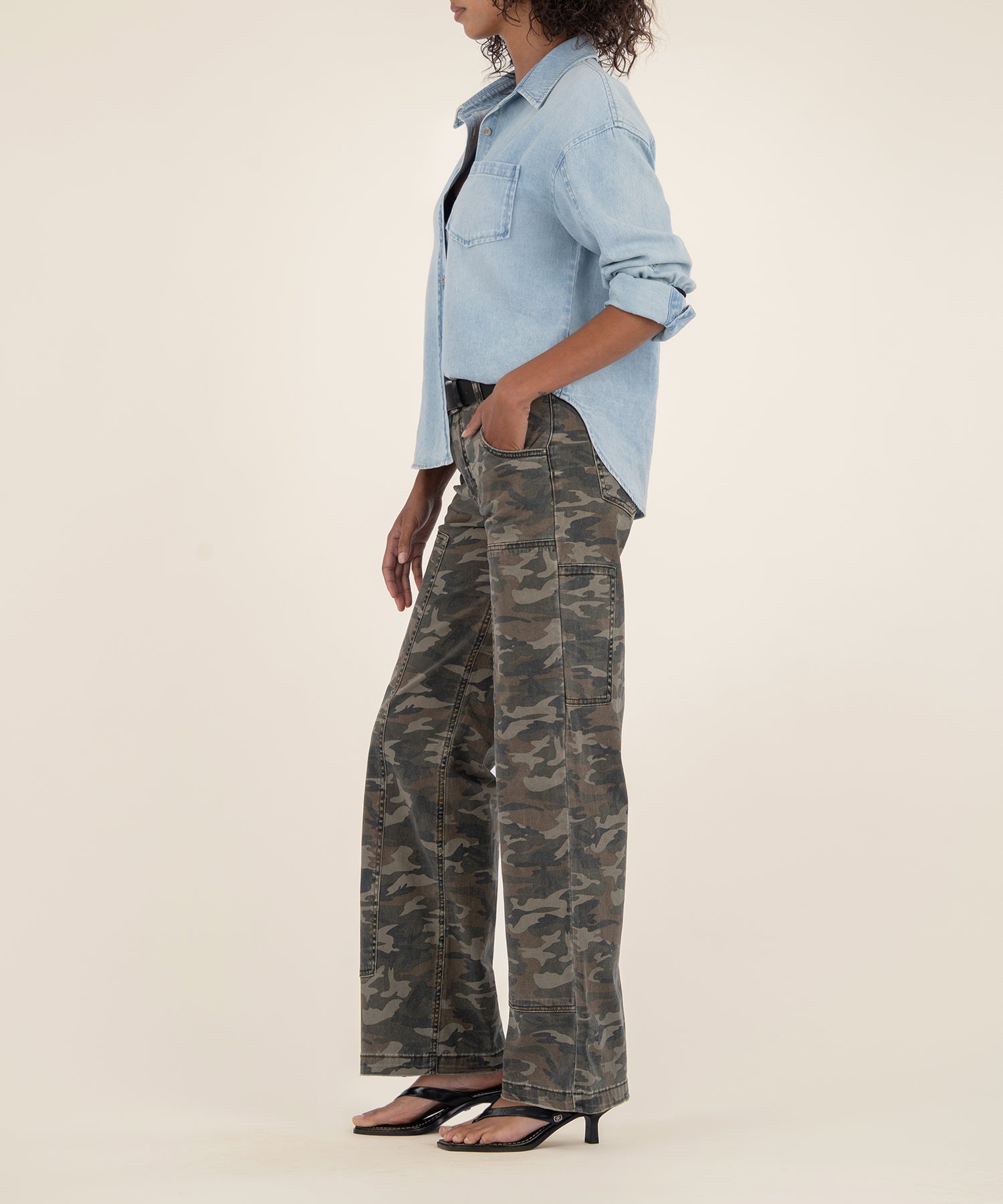 Olive camouflage high-rise wide-leg jeans with center seam, styled with light blue denim shirt.