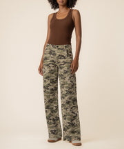 Wide-leg jeans in olive and tan camouflage print with high-rise waist, shown with brown tank top.