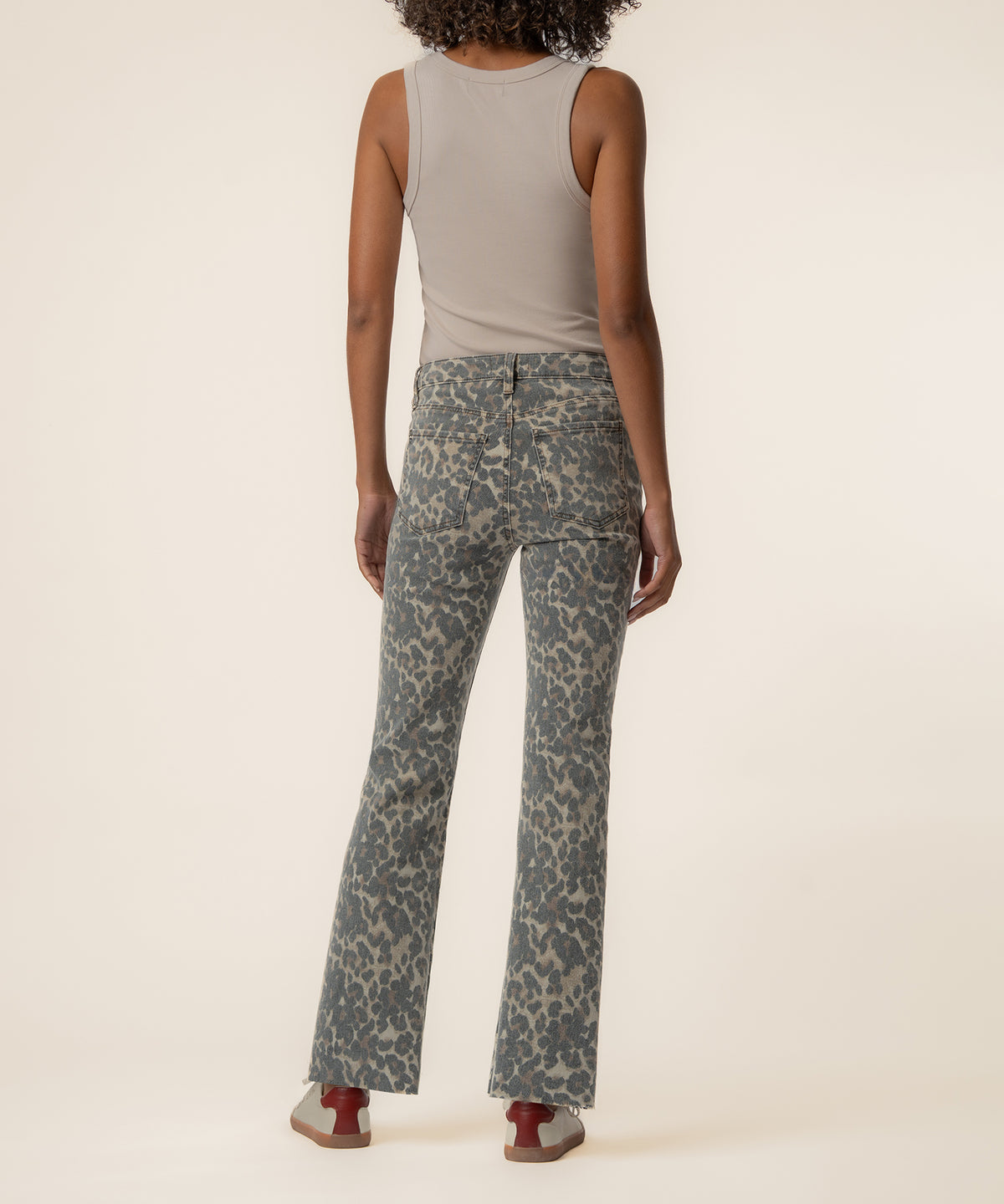 Tan and brown leopard print high-rise flare jeans with long inseam, shown from back view.