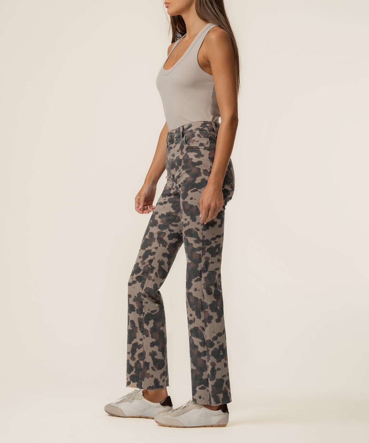 Taupe ankle flare jeans with charcoal leopard print, high rise waist, paired with light gray tank top and white sneakers.