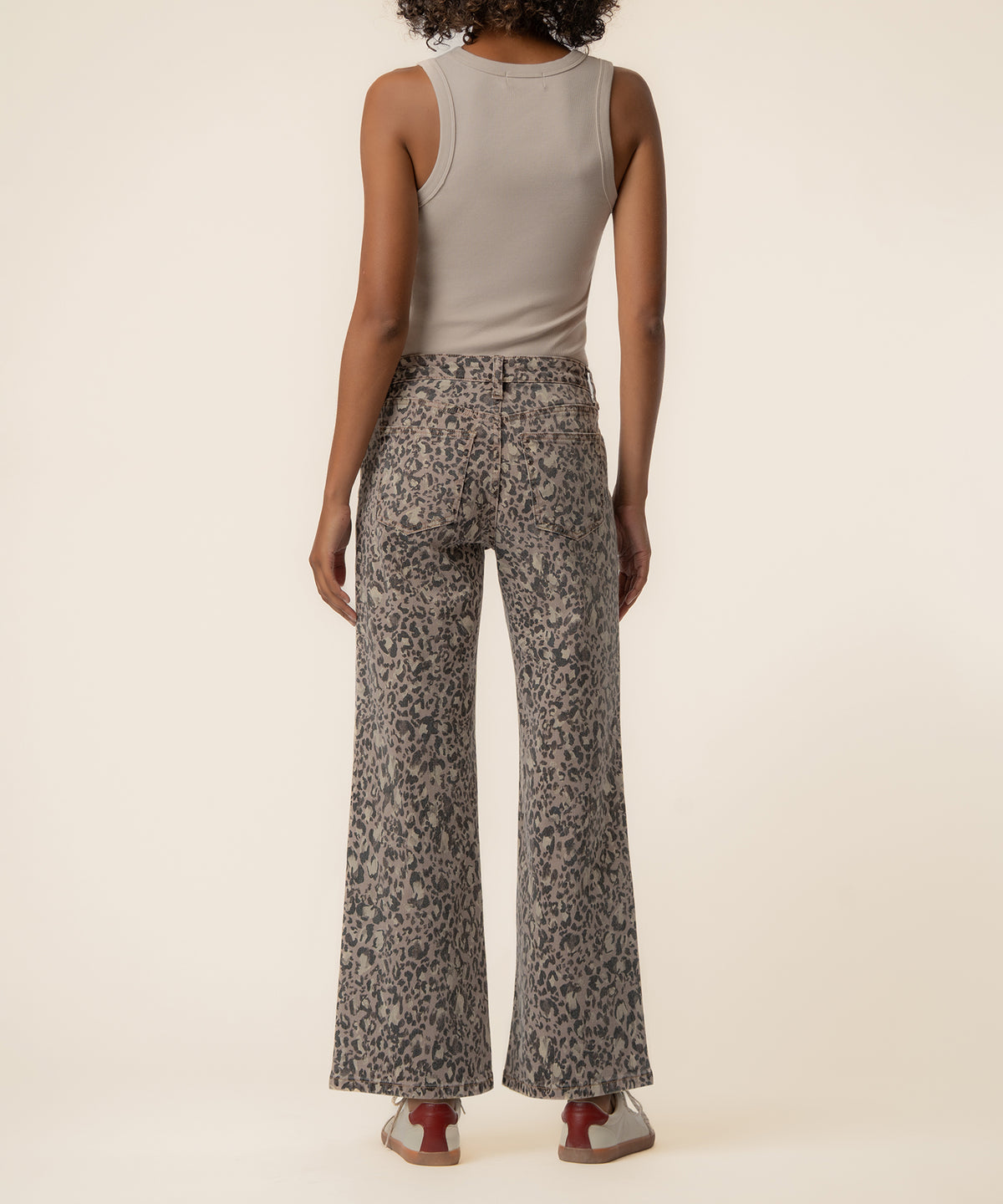 Taupe high-rise wide-leg jeans with gray leopard print pattern, shown from back on model wearing neutral tank top.