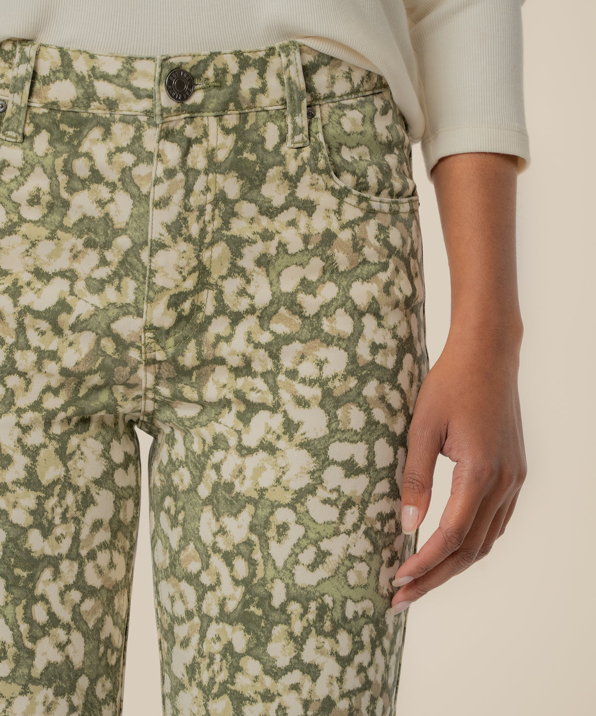 Dark olive floral print high-rise ankle flare jeans with button closure and front pocket detail.