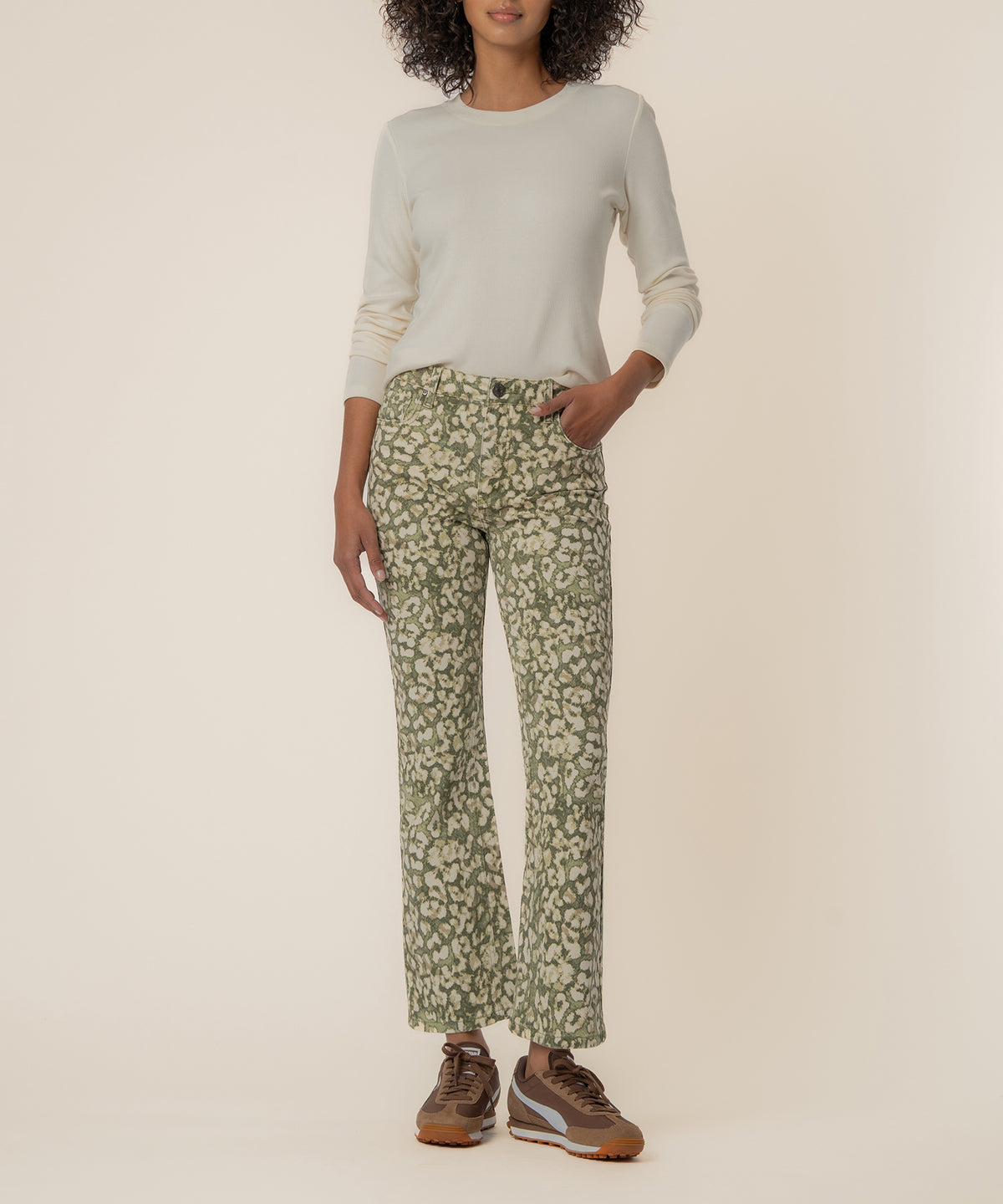 Dark olive floral ankle flare jeans with high rise waistband, shown with cream long-sleeve top.