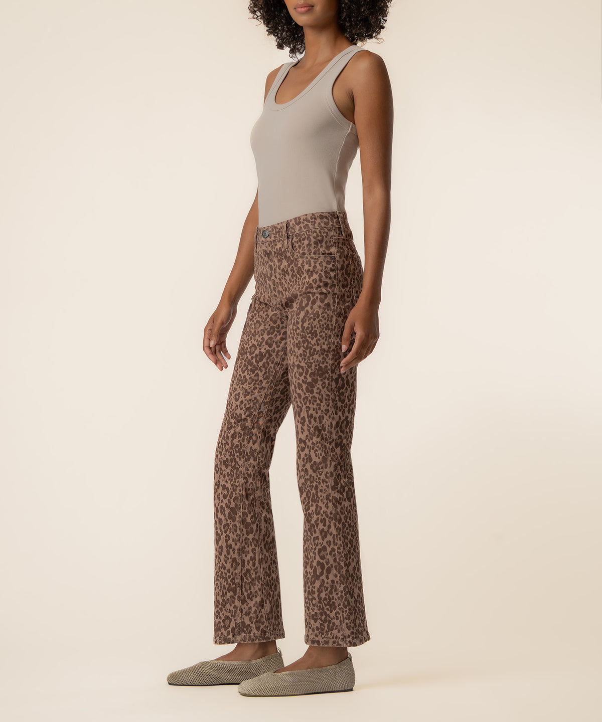 Chestnut leopard print high-rise ankle flare jeans with a flared hem, styled with a cream tank top.