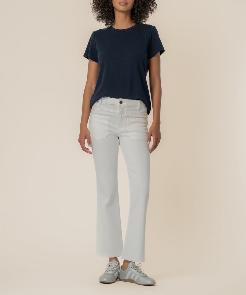 White high-rise flare jeans with front pockets and button waistband, styled with navy short-sleeve t-shirt.