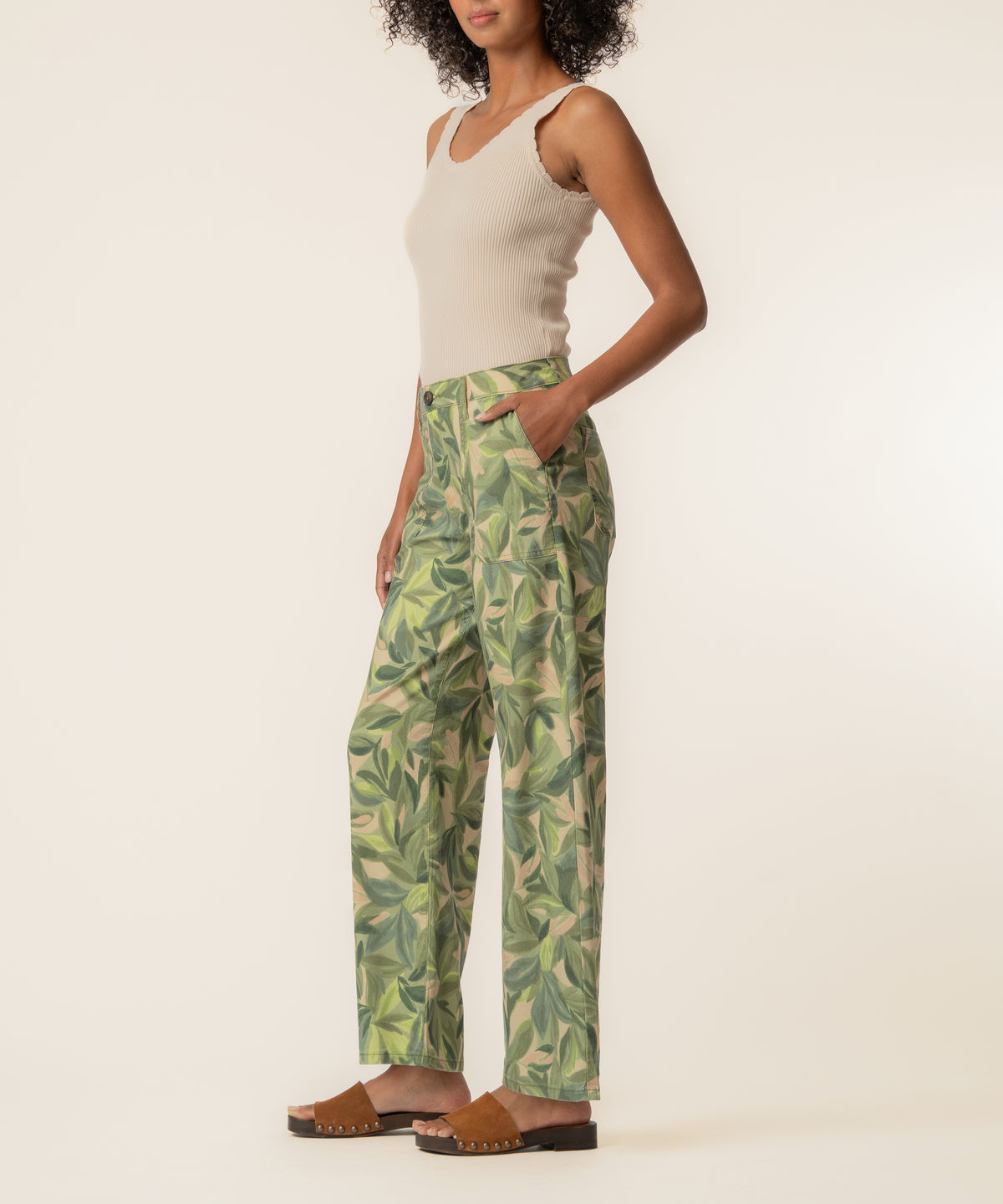 Olive linen high-waist straight pants with leaf print, paired with cream ribbed tank top.