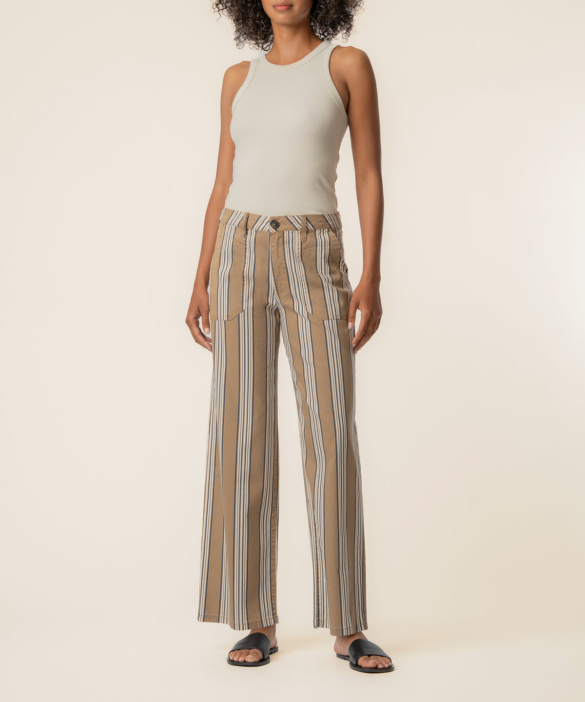 Taupe linen pants with vertical stripes, high waist, and straight leg silhouette on model.