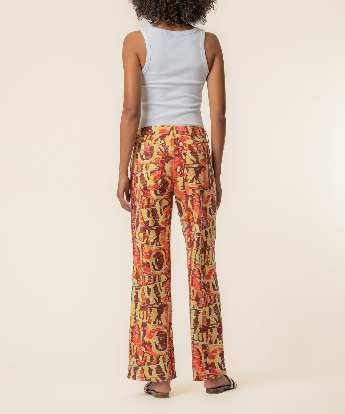 High-waist straight-leg pants in wine, yellow, and orange print linen fabric with front pockets.