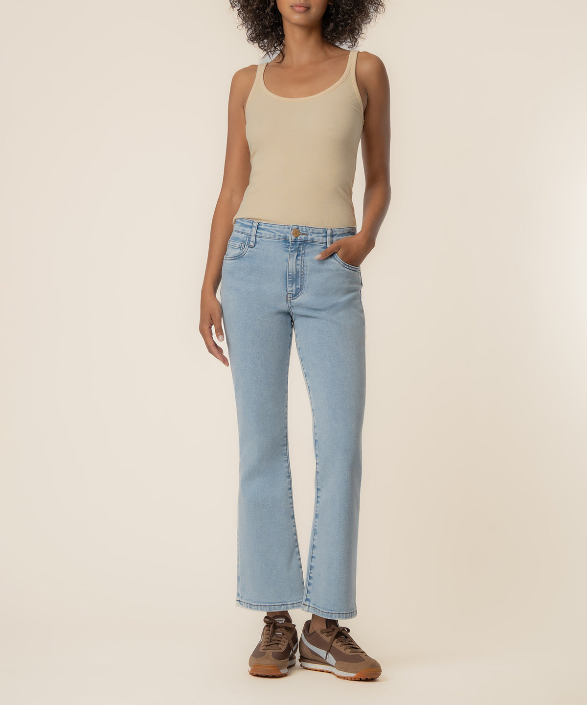 Light blue high-rise ankle flare jeans with a subtle wash, worn with a beige tank top.