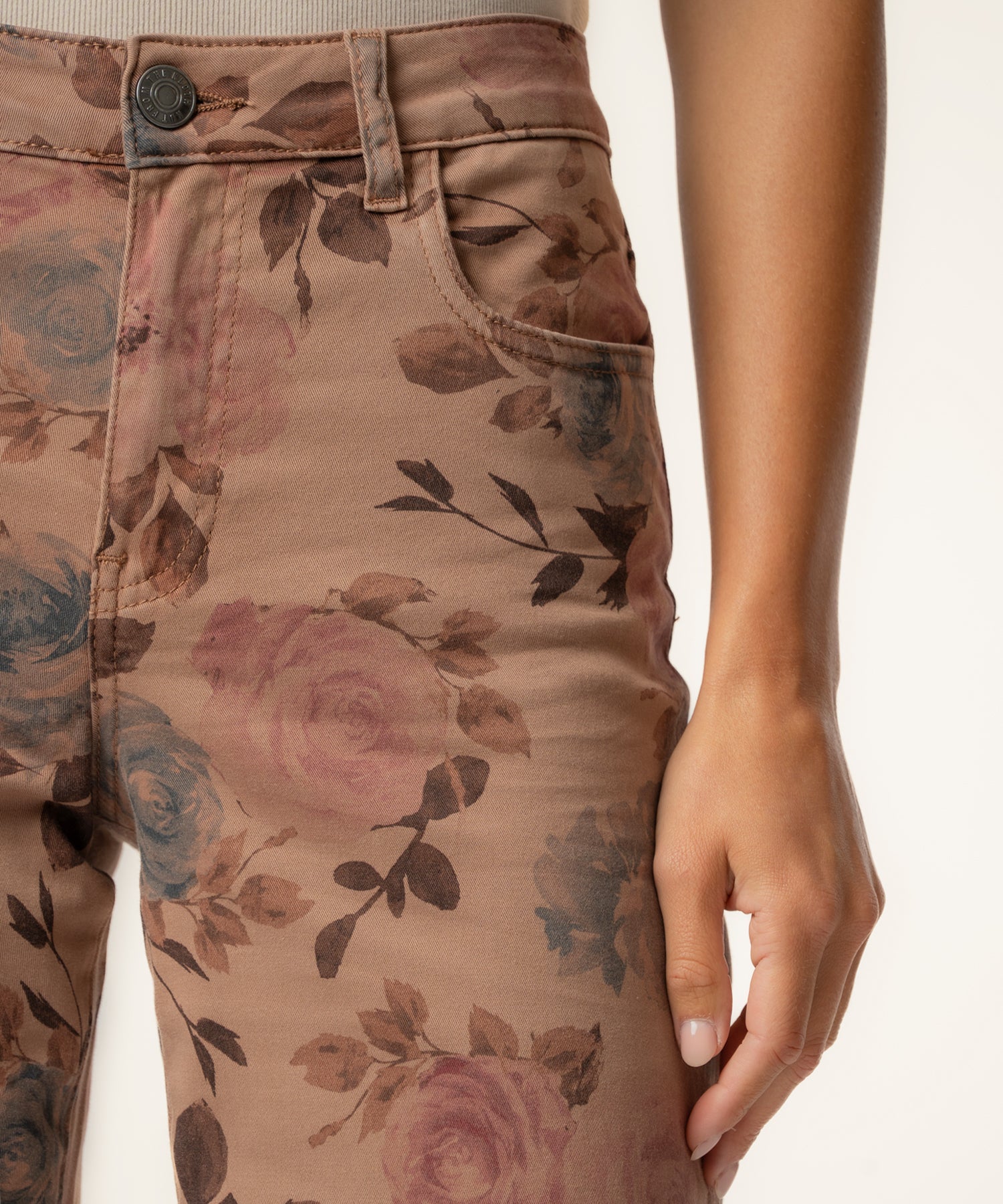 Mauve twill pants with floral print, high rise waistband with button closure, wide leg silhouette.