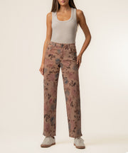 Mauve twill wide-leg pants with floral print, high-rise waistband, worn with cream tank top.