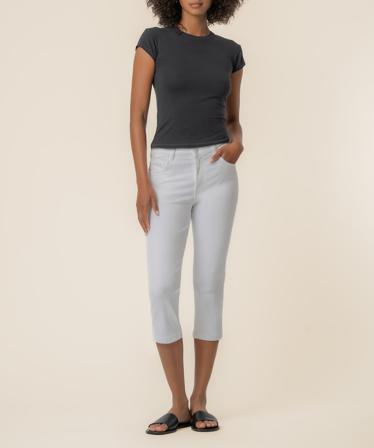 White high-rise capri pants with front pockets, styled with a black short-sleeve tee.