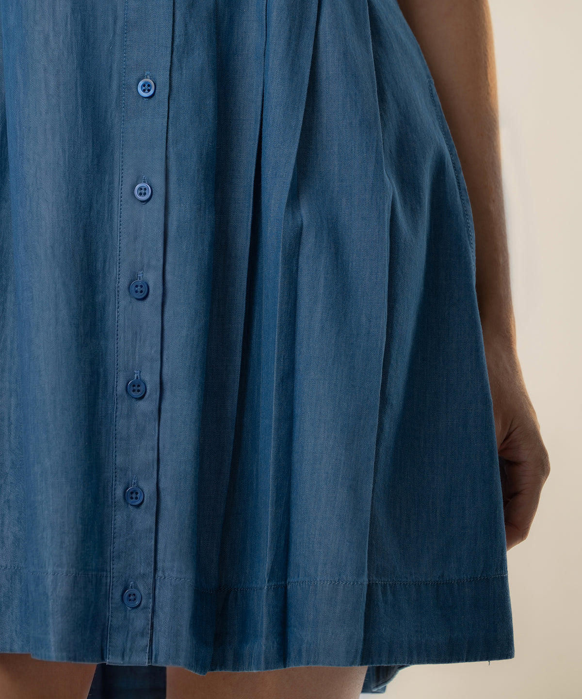Blue denim dress with button front and A-line silhouette.