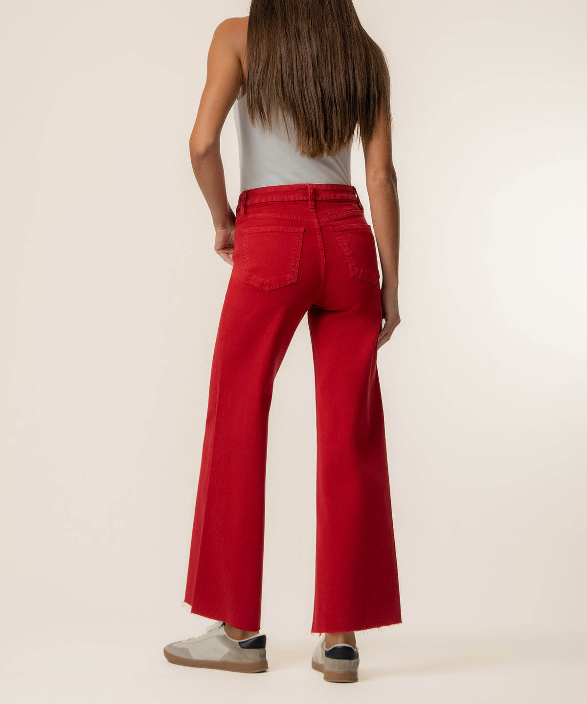 Ruby red high-rise wide-leg jeans with five-pocket styling and raw hem, back view.