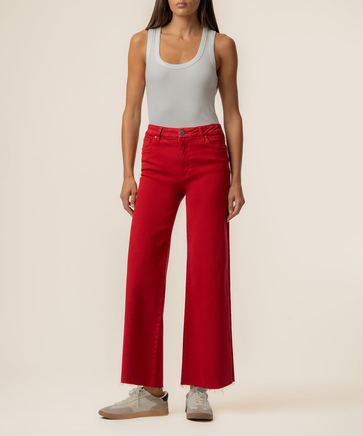 Ruby red high-rise wide-leg jeans with a five-pocket design, shown with a white tank top.
