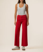 Ruby red high-rise wide-leg jeans with a five-pocket design, shown with a white tank top.