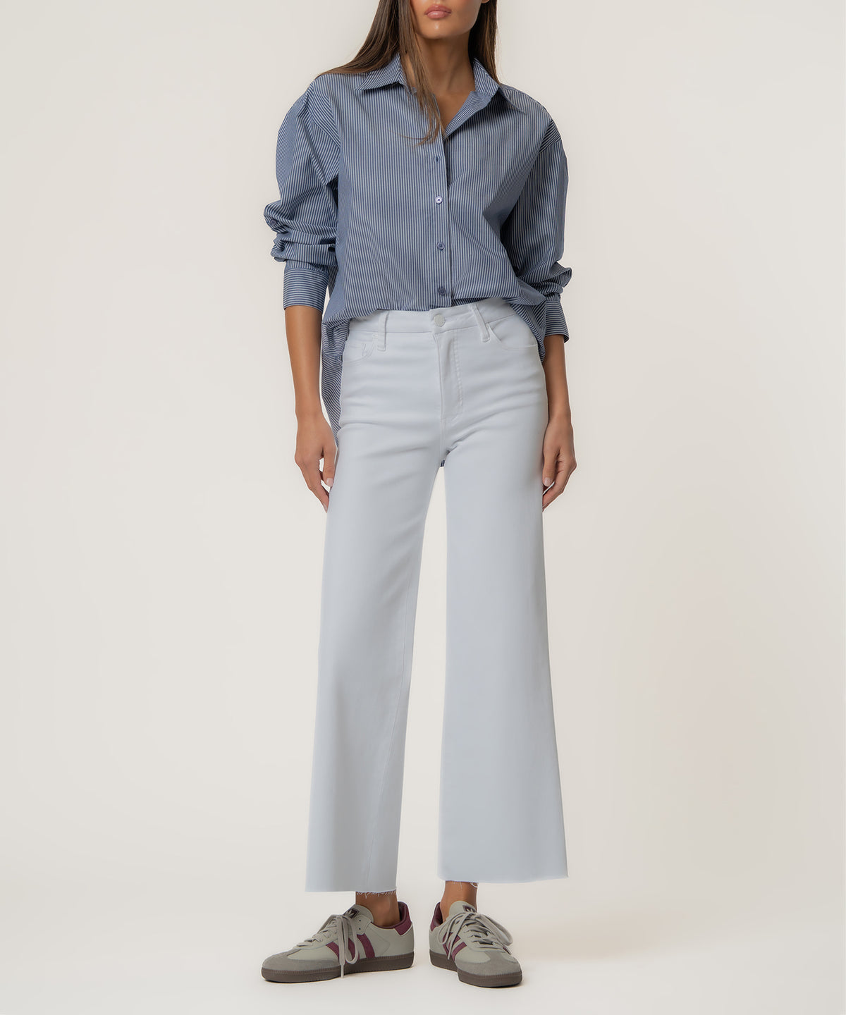 White high-rise wide-leg jeans with button fly and five-pocket styling.