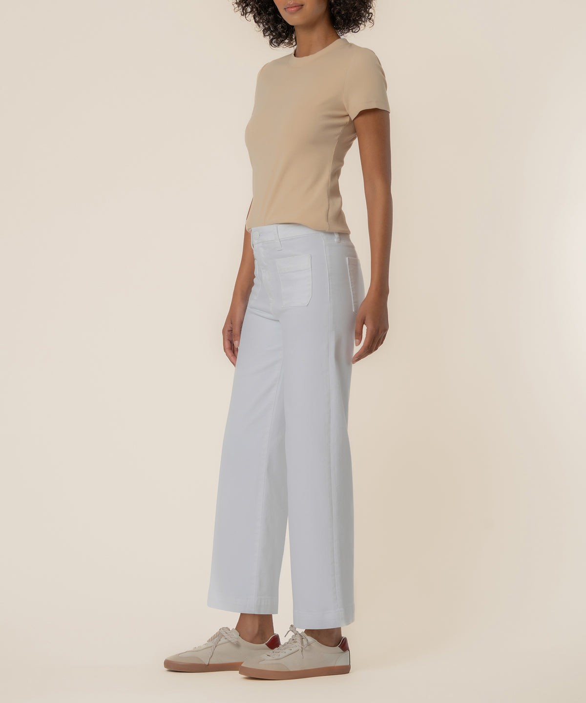 White high-rise wide-leg jeans with five-pocket styling and ankle-length cut on a model.