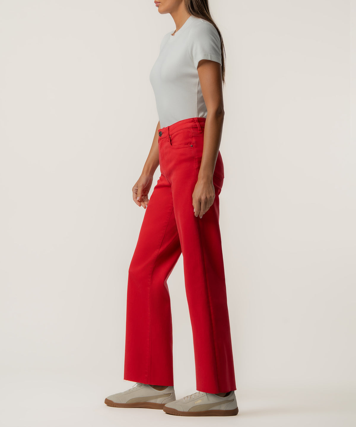 Woman wearing scarlet red high-rise wide-leg pants with long inseam and white t-shirt.