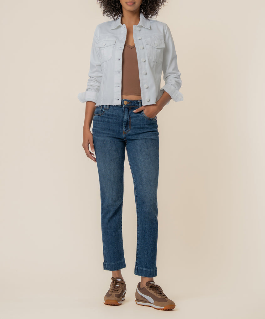 White denim jacket with collar, button front, and chest pockets worn over blue jeans.