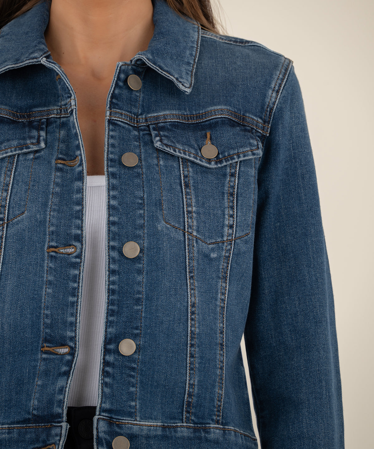 Blue denim crop jacket with collar, button front, chest pockets, and contrast stitching detail.