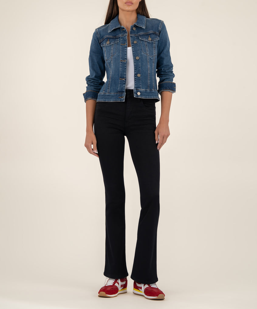 Cropped blue denim jacket with button front and chest pockets worn over white top and black pants.