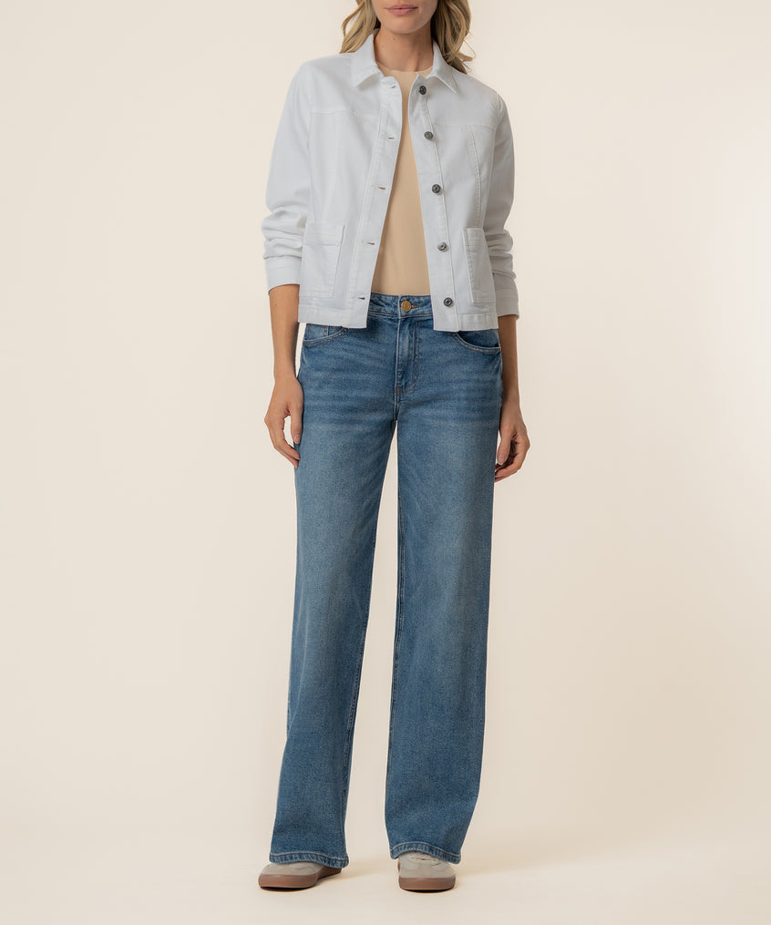 White cropped trucker jacket with button front and chest pockets, worn with blue jeans.