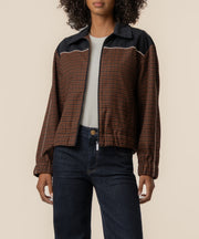 Black and brown plaid track jacket with collared neckline and white striping detail.