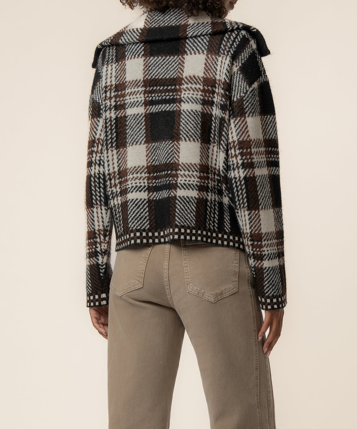 Chocolate brown and cream plaid knit jacket with turtleneck and textured cuff details, shown from back.