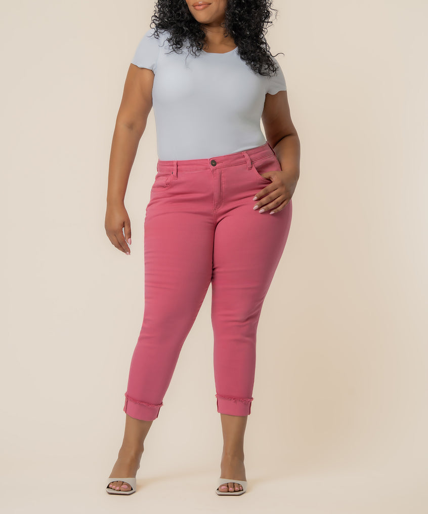 Flamingo pink mid-rise crop straight leg jeans with rolled cuffs, styled with white t-shirt and slides.
