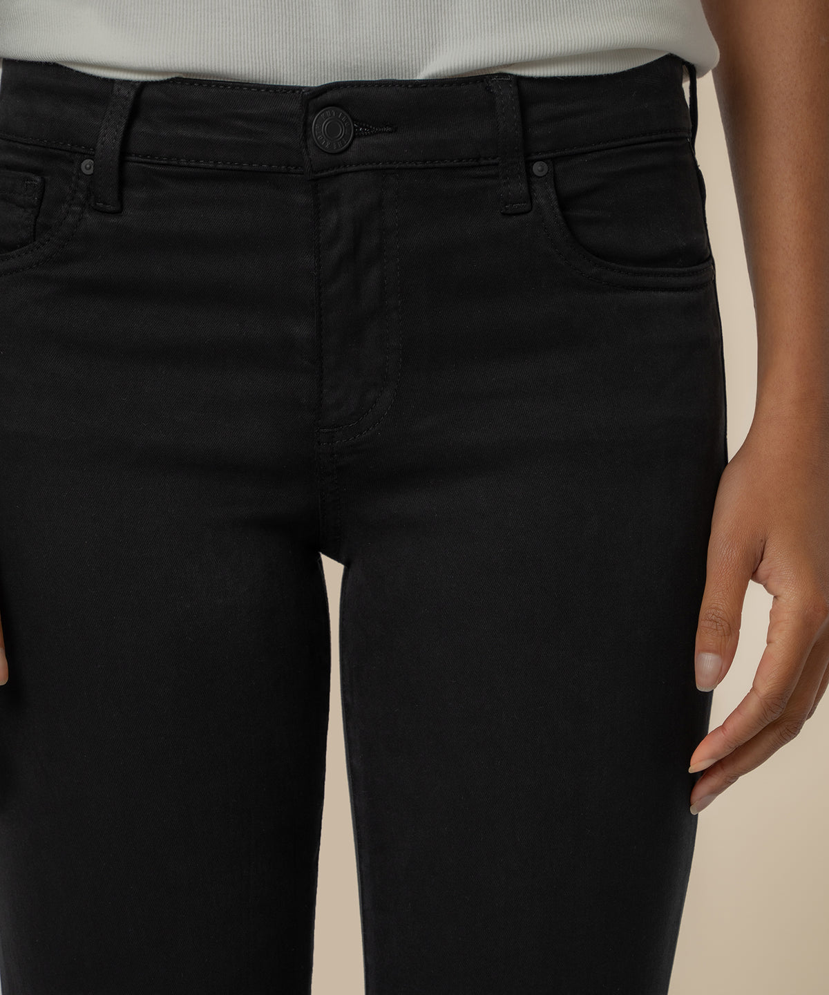 Black mid-rise crop straight leg jeans with button and zip closure, worn with white ribbed top.