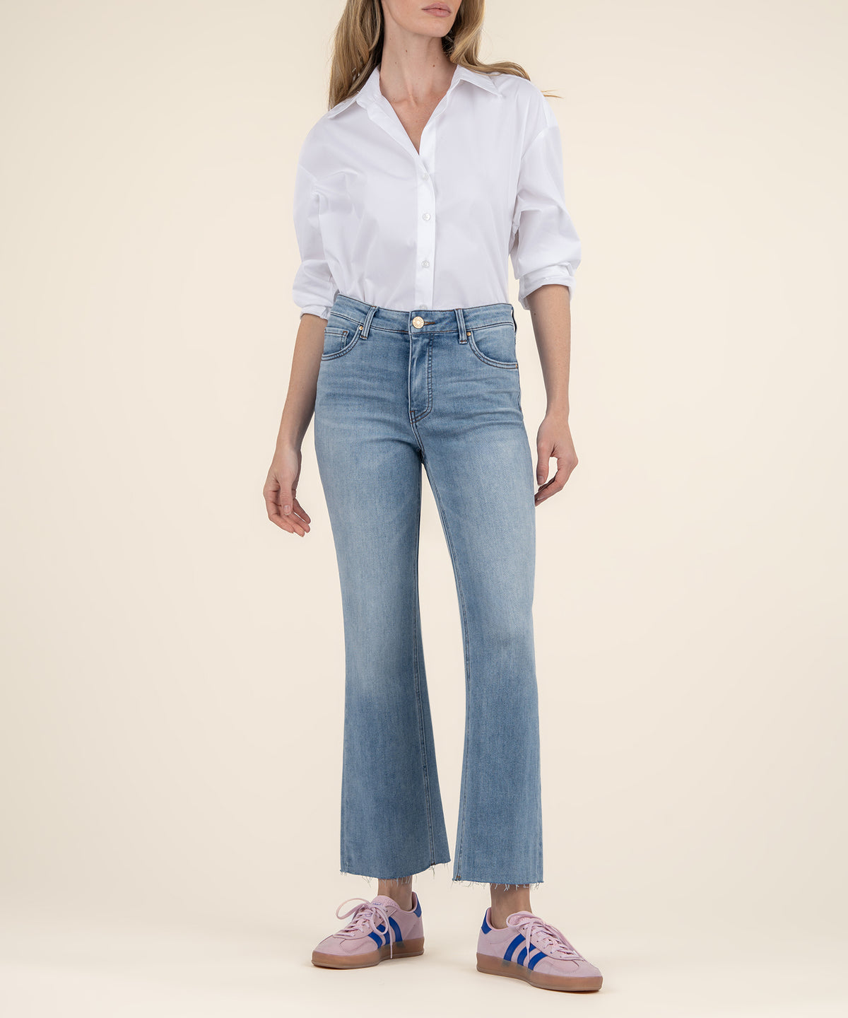 Light blue ankle flare jeans with high rise waistband, styled with white button-up shirt.
