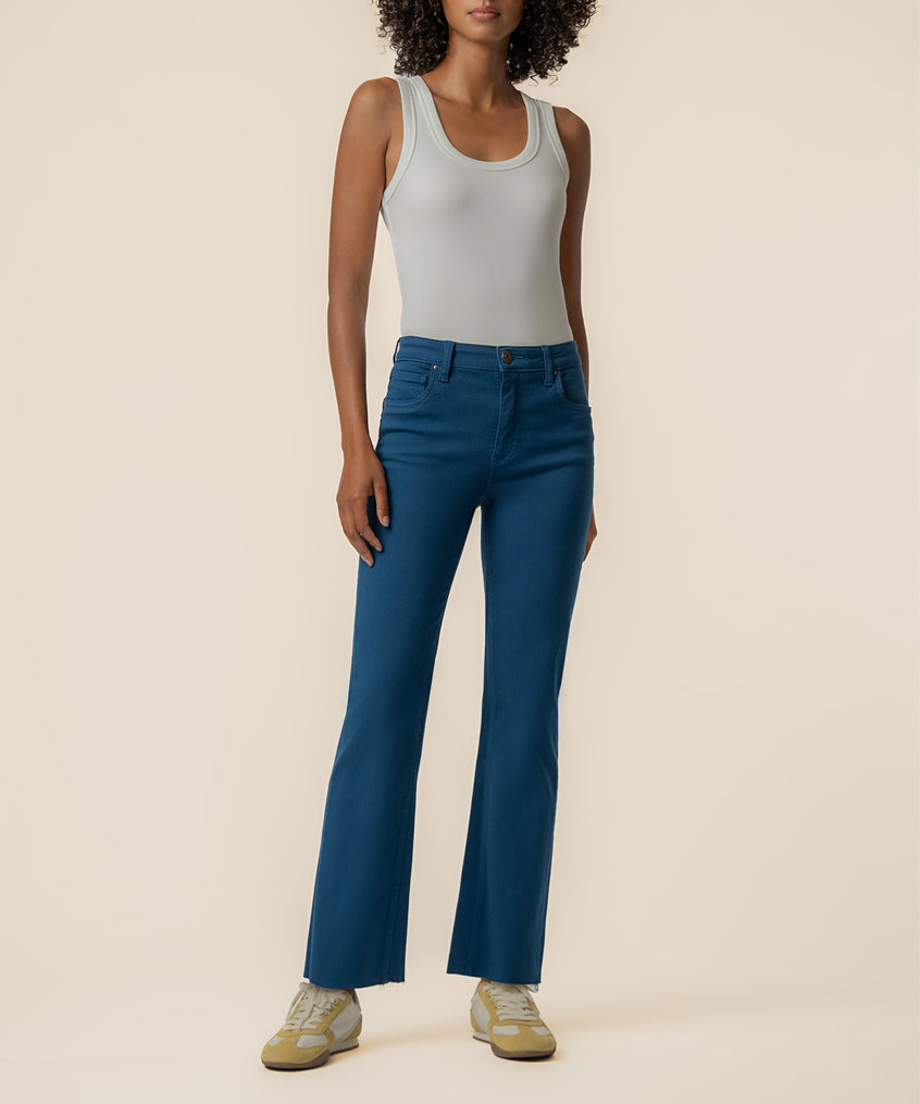 Dark blue high-rise ankle flare jeans with frayed hem, shown with light gray tank top.