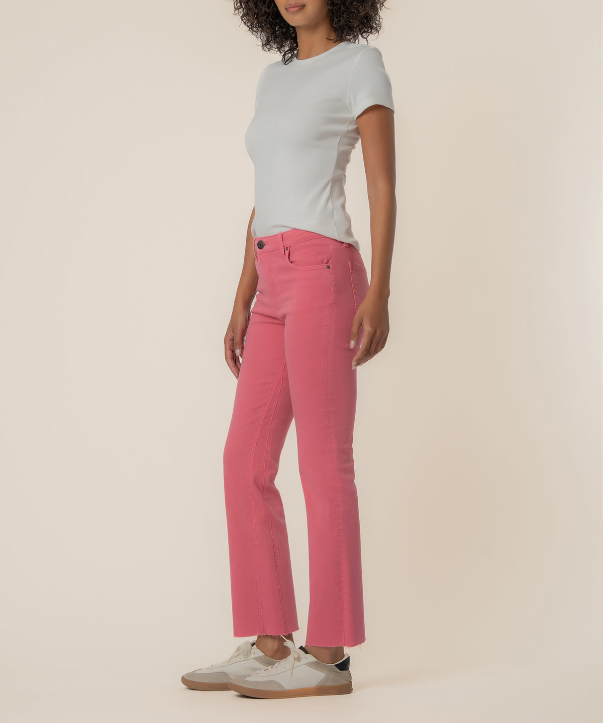 Pink high-rise ankle flare jeans with slight flair at hem, shown with white t-shirt and sneakers.