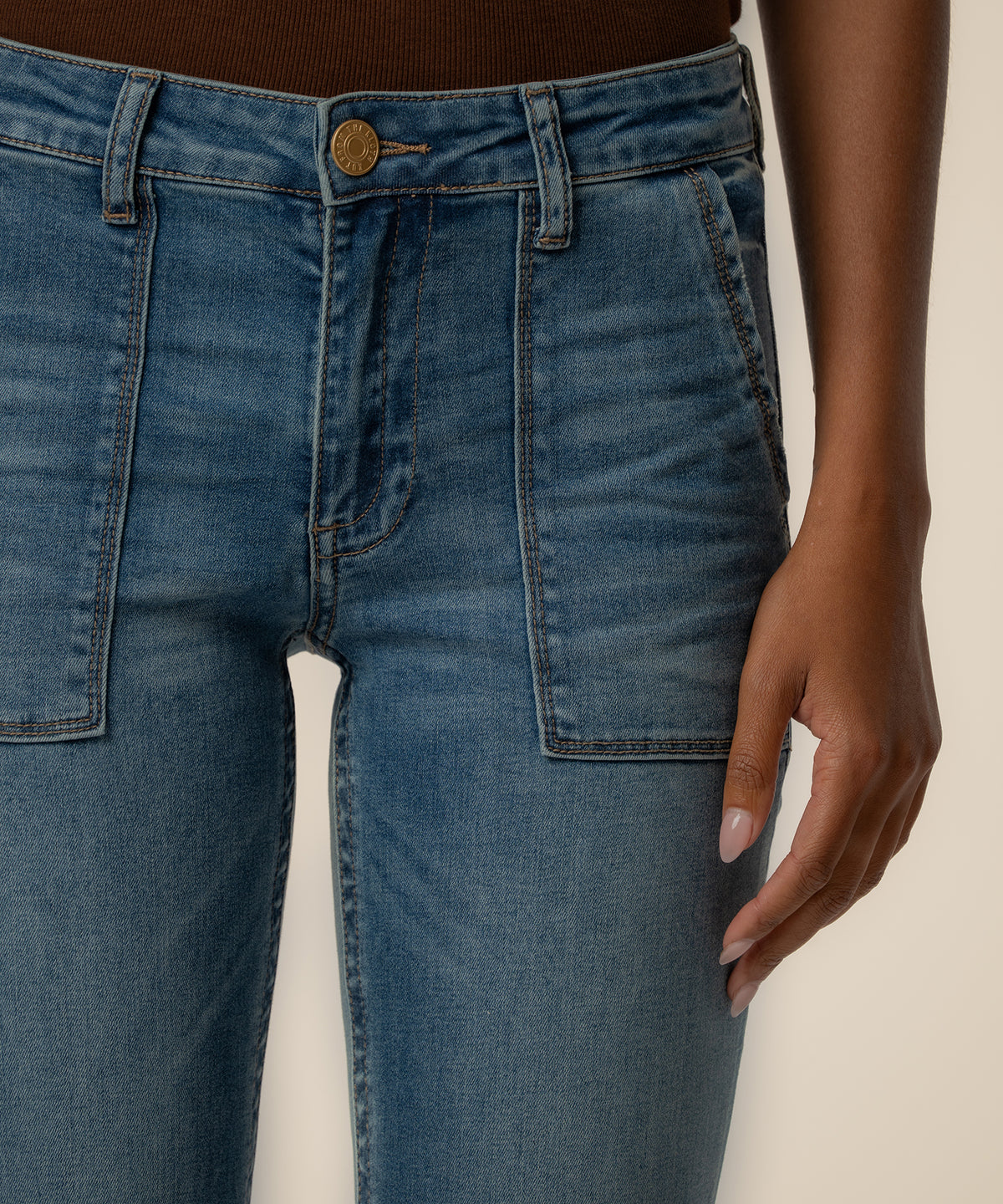 Medium-wash straight-leg jeans with high rise waistband, button fly, and front patch pockets.