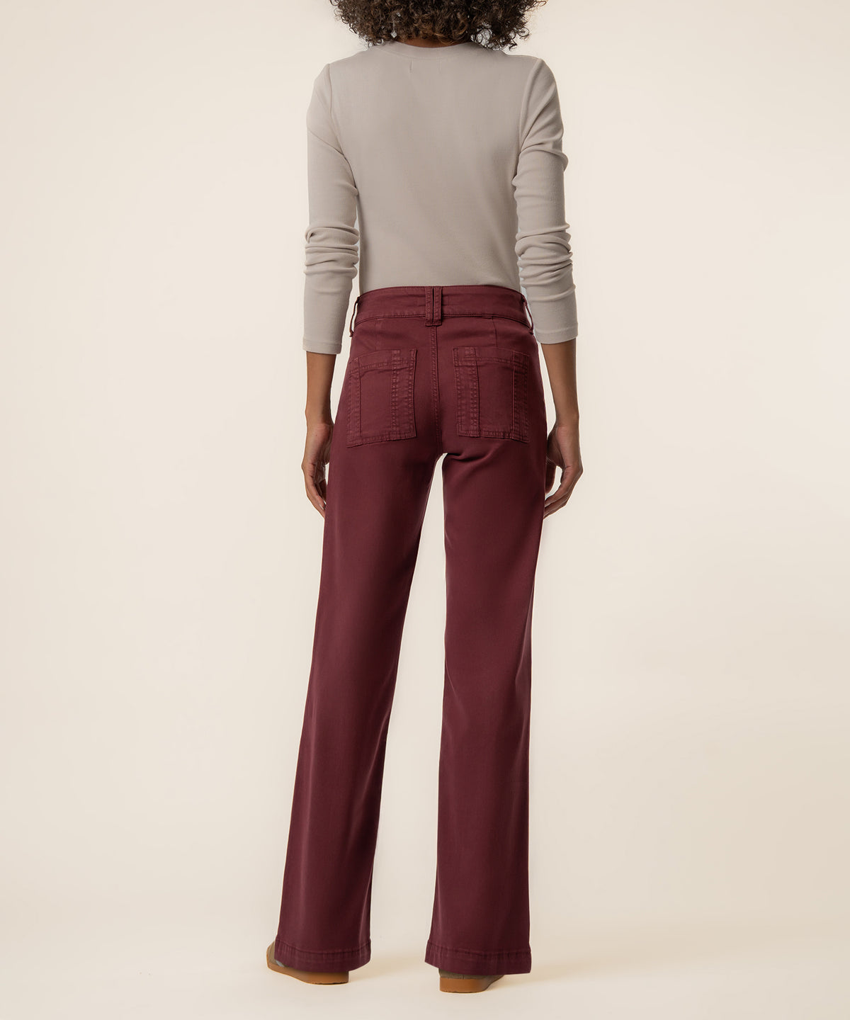 Claret twill straight leg pants with high rise waist and back pockets, worn with beige long-sleeve top.