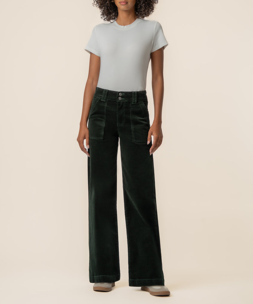 Dark forest corduroy high-rise wide-leg pants with patch pockets, styled with a light gray t-shirt.