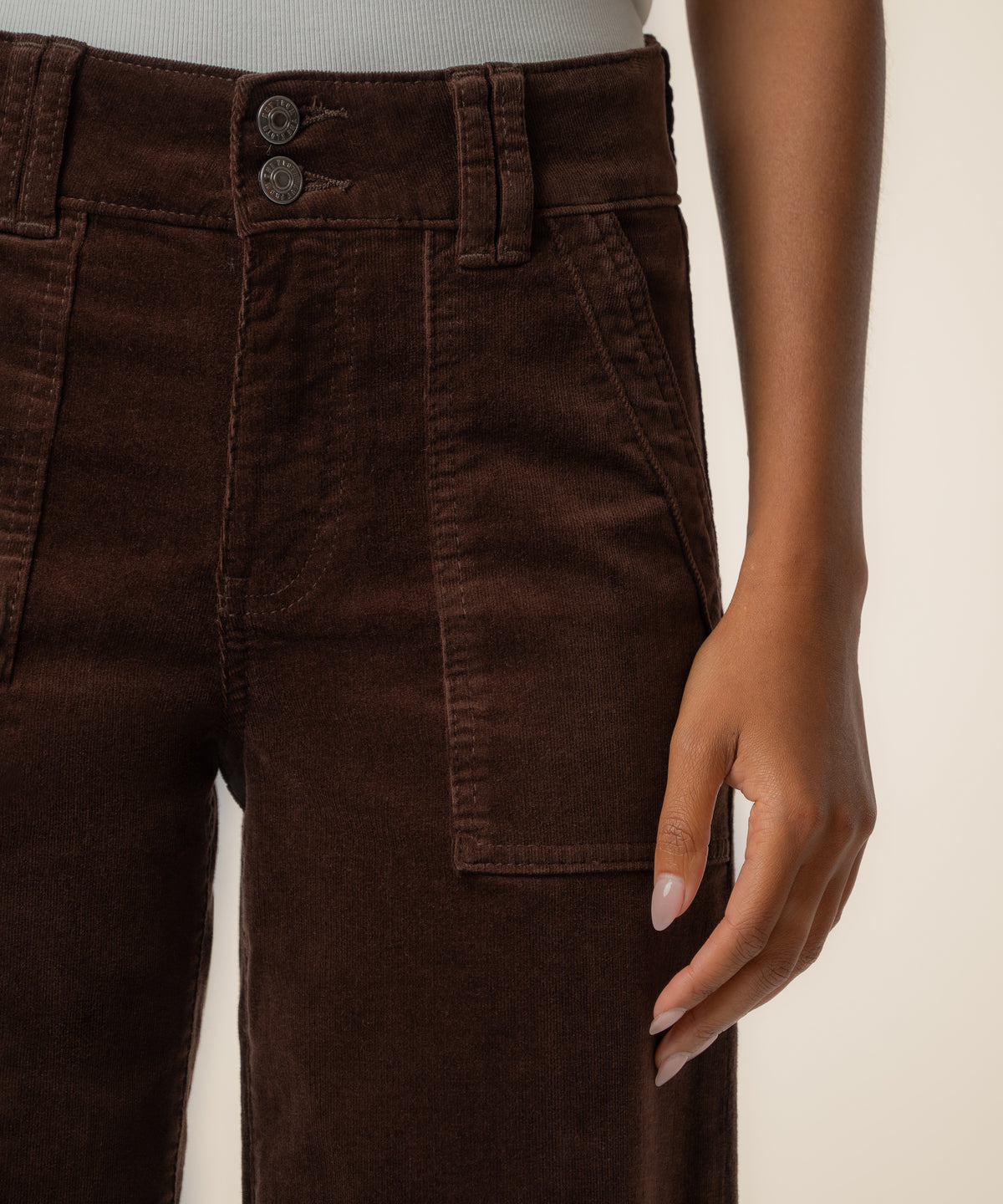 Truffle brown corduroy high-rise pants with wide straight legs and front patch pockets.