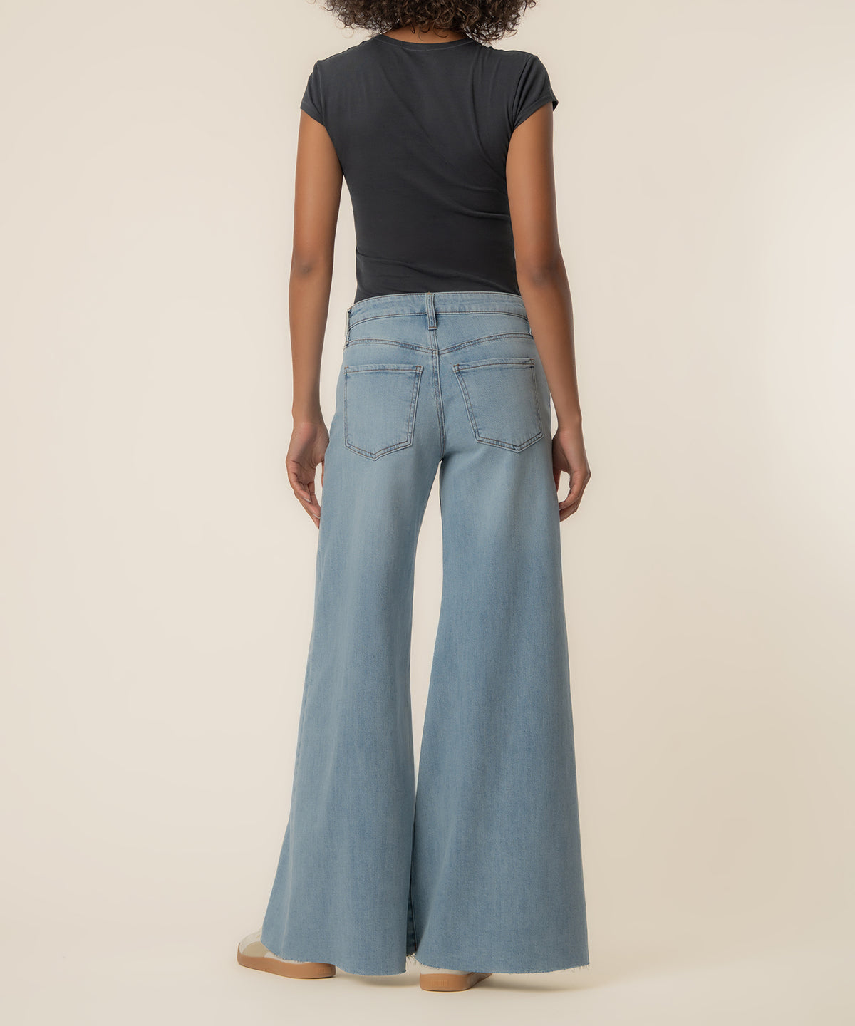 Light blue high-rise jeans with super wide legs and five-pocket styling, shown from back view.