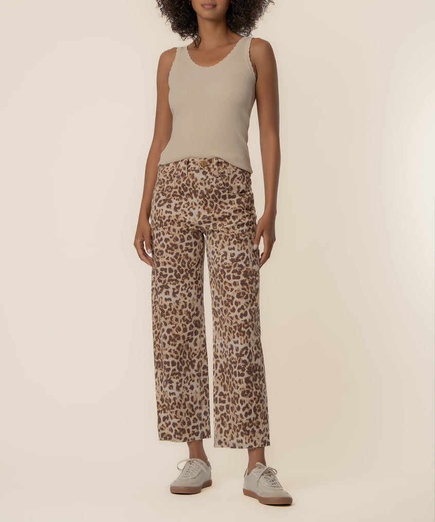 Tan and brown leopard print high-rise wide leg pants worn with a cream ribbed tank top and white platform sneakers.