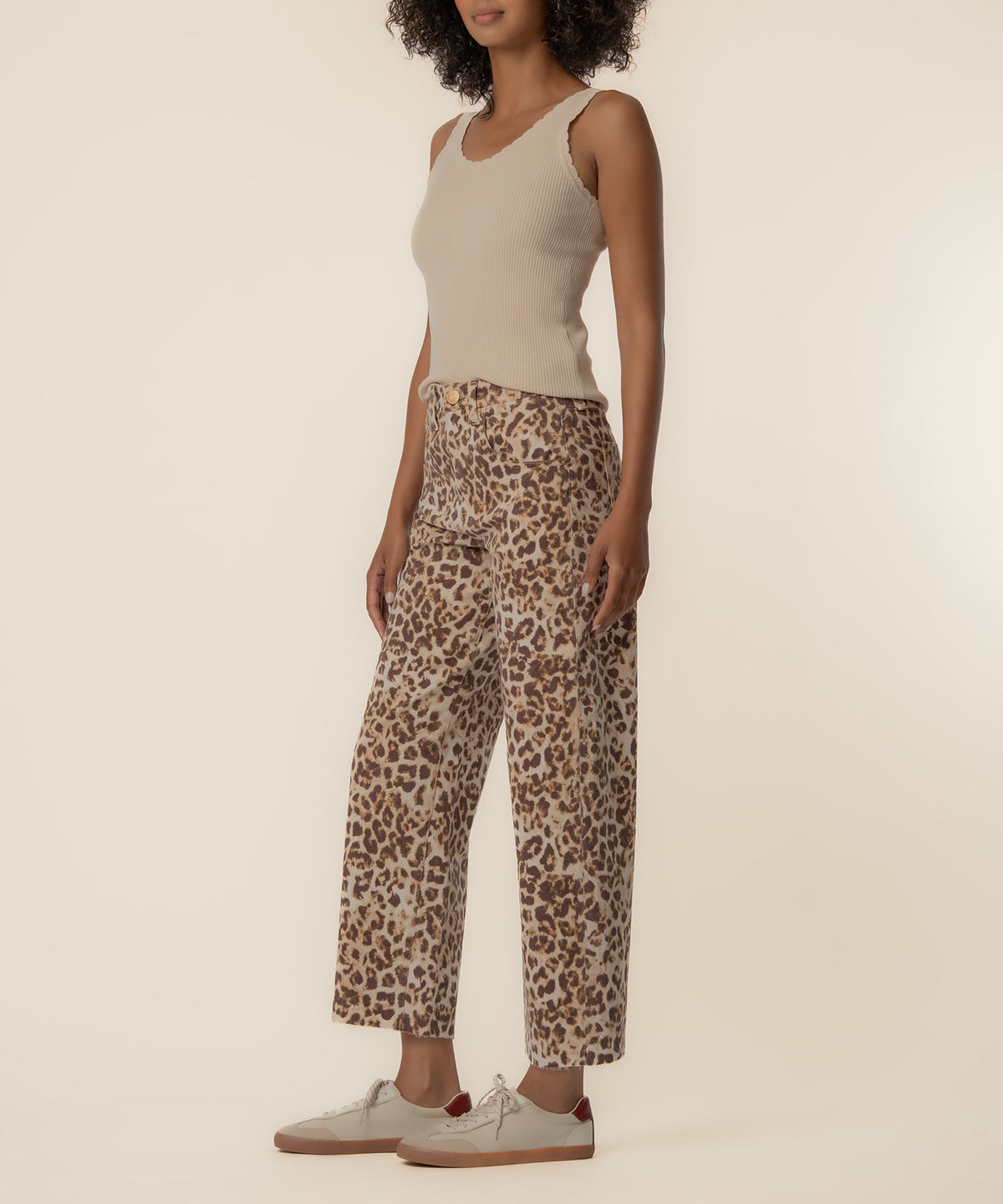 Tan and brown leopard print high-rise wide leg pants with cropped ankle length on model wearing cream sleeveless tank.