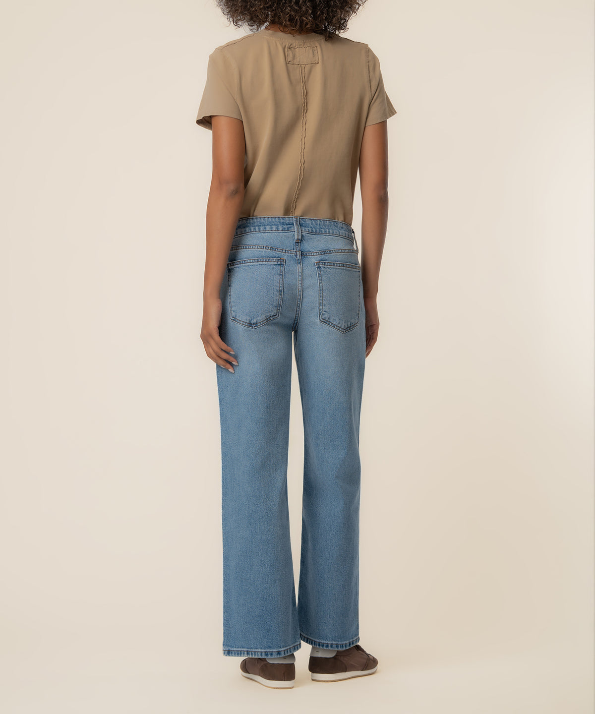 Low-rise straight leg jeans in light blue wash with five-pocket styling, shown from back.