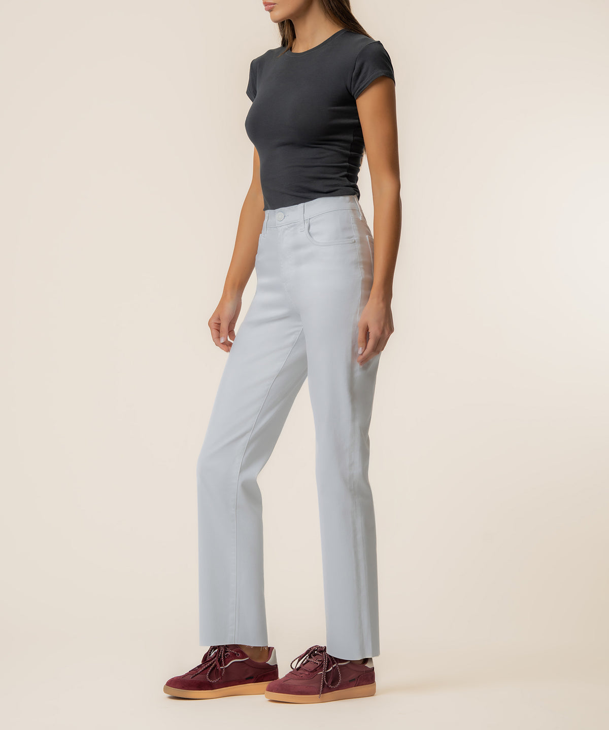 Woman wearing light blue high-rise straight-leg jeans with a dark gray t-shirt and burgundy lace-up boots.