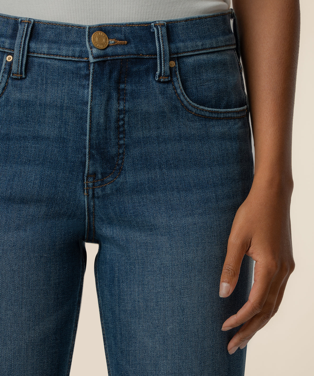 High-rise straight-leg jeans in dark blue razor wash denim with gold button closure and classic five-pocket styling.