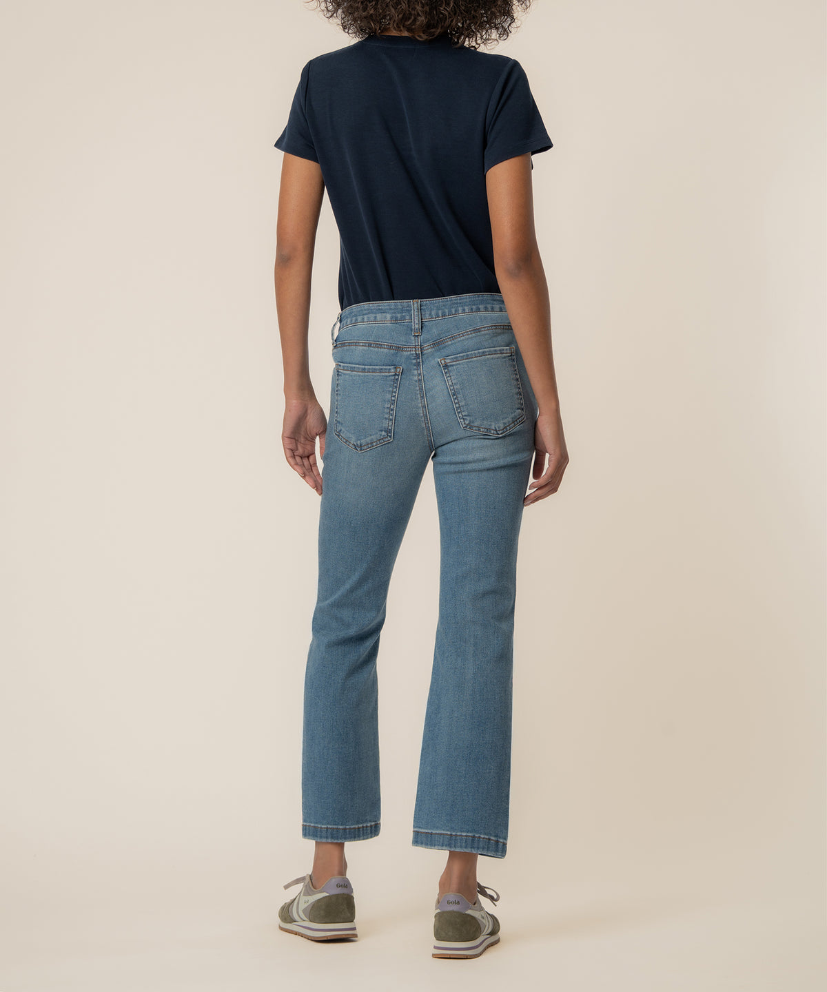 Light blue denim ankle flare jeans with high rise waist and articulated wash, shown from back.
