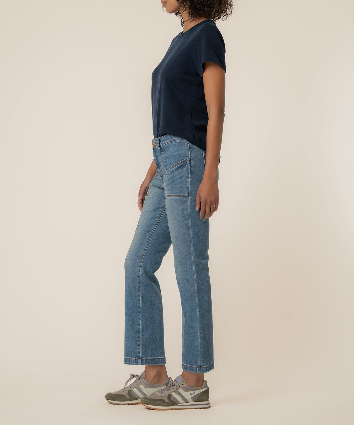 Light blue high-rise ankle flare jeans with articulated wash, worn with navy t-shirt.
