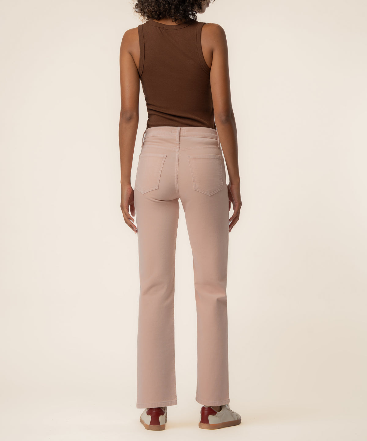Pink corduroy high-rise straight-leg pants with five-pocket styling, shown from back view on model.