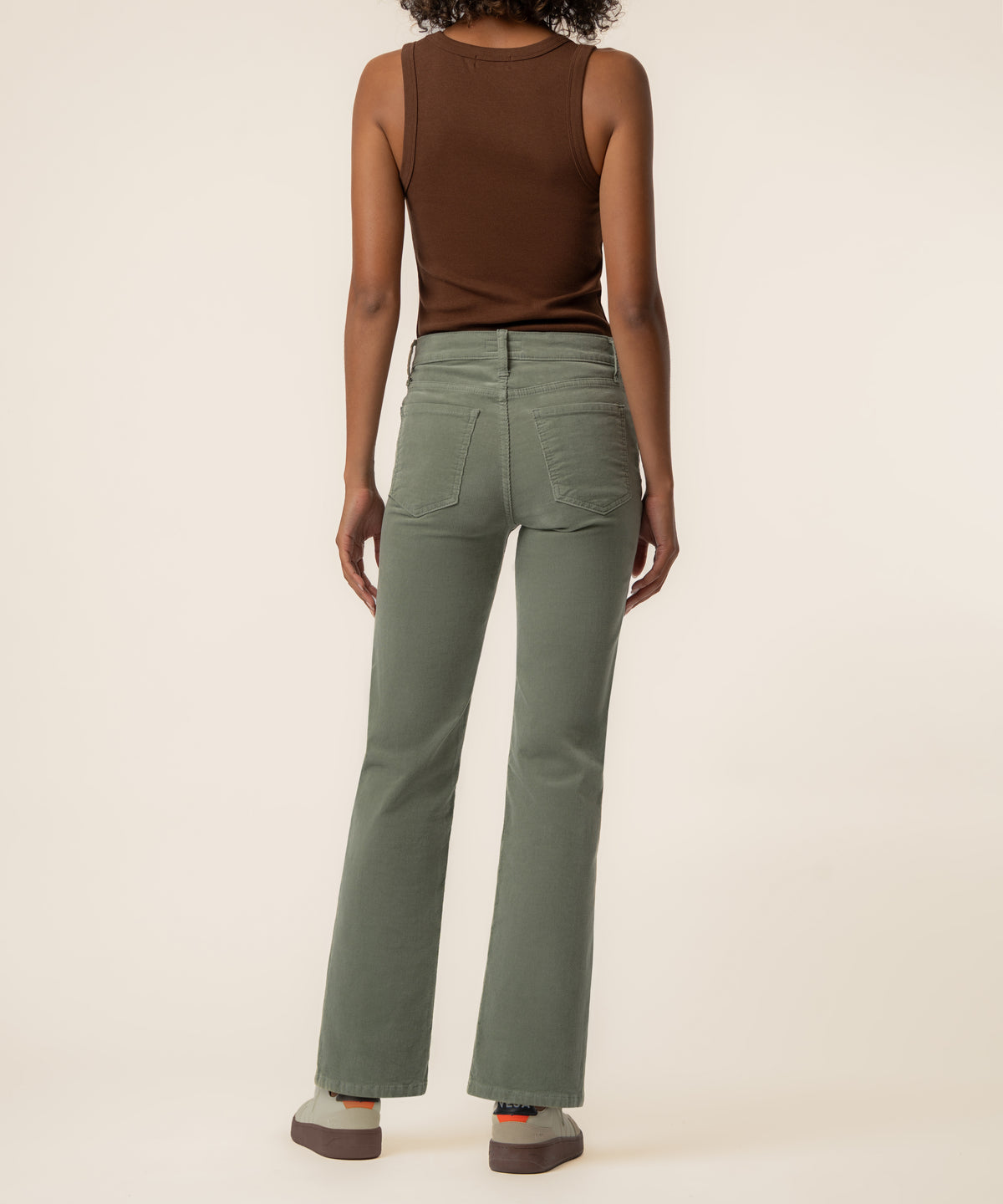 Sea star green corduroy high rise straight leg pants with five-pocket styling, shown from back view.