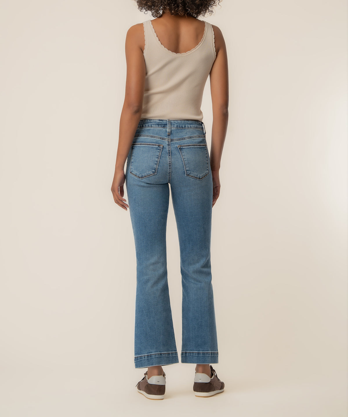 Blue high-rise flare jeans with five-pocket styling and visible stitching on the hem.